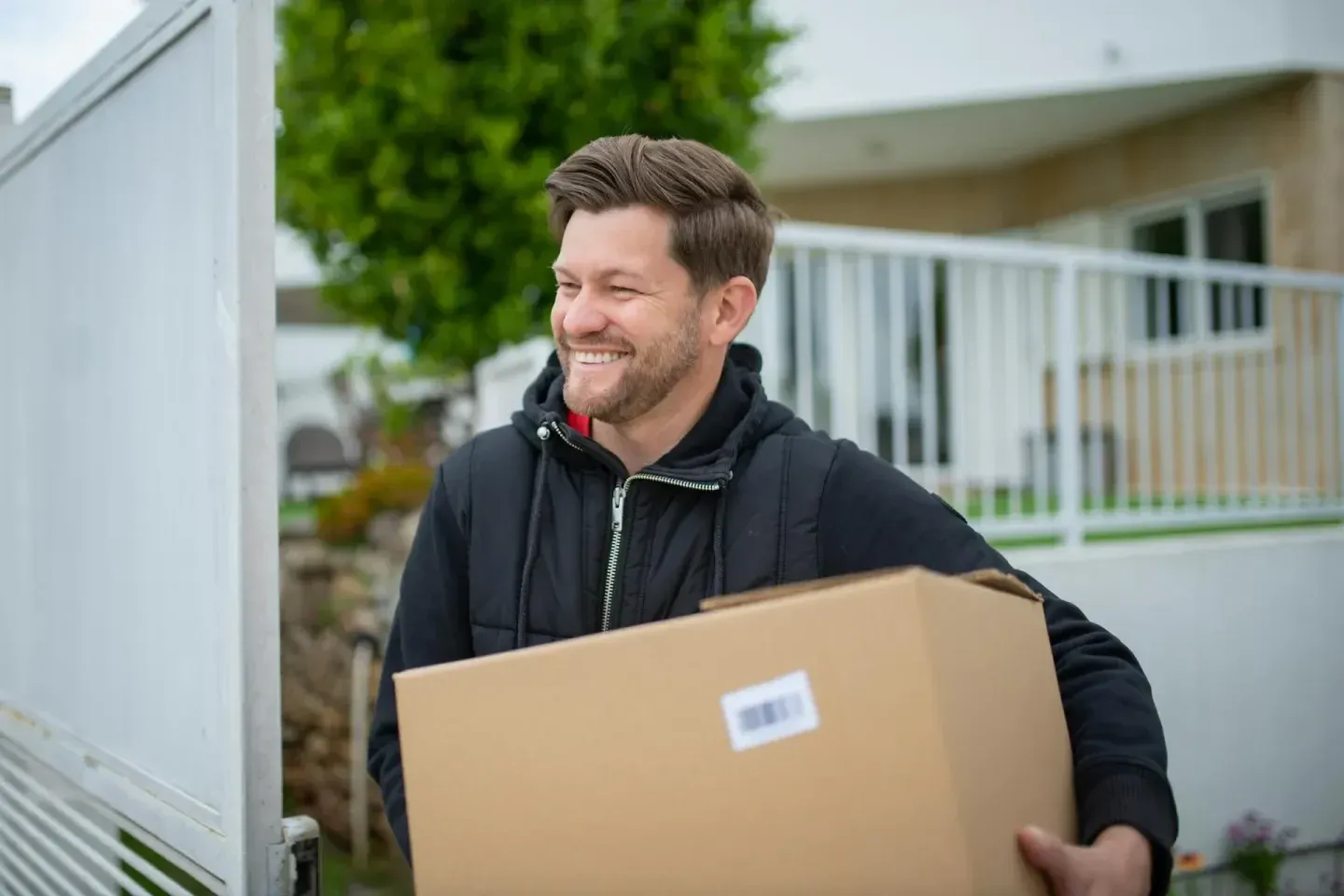 Man carrying a package outside a building